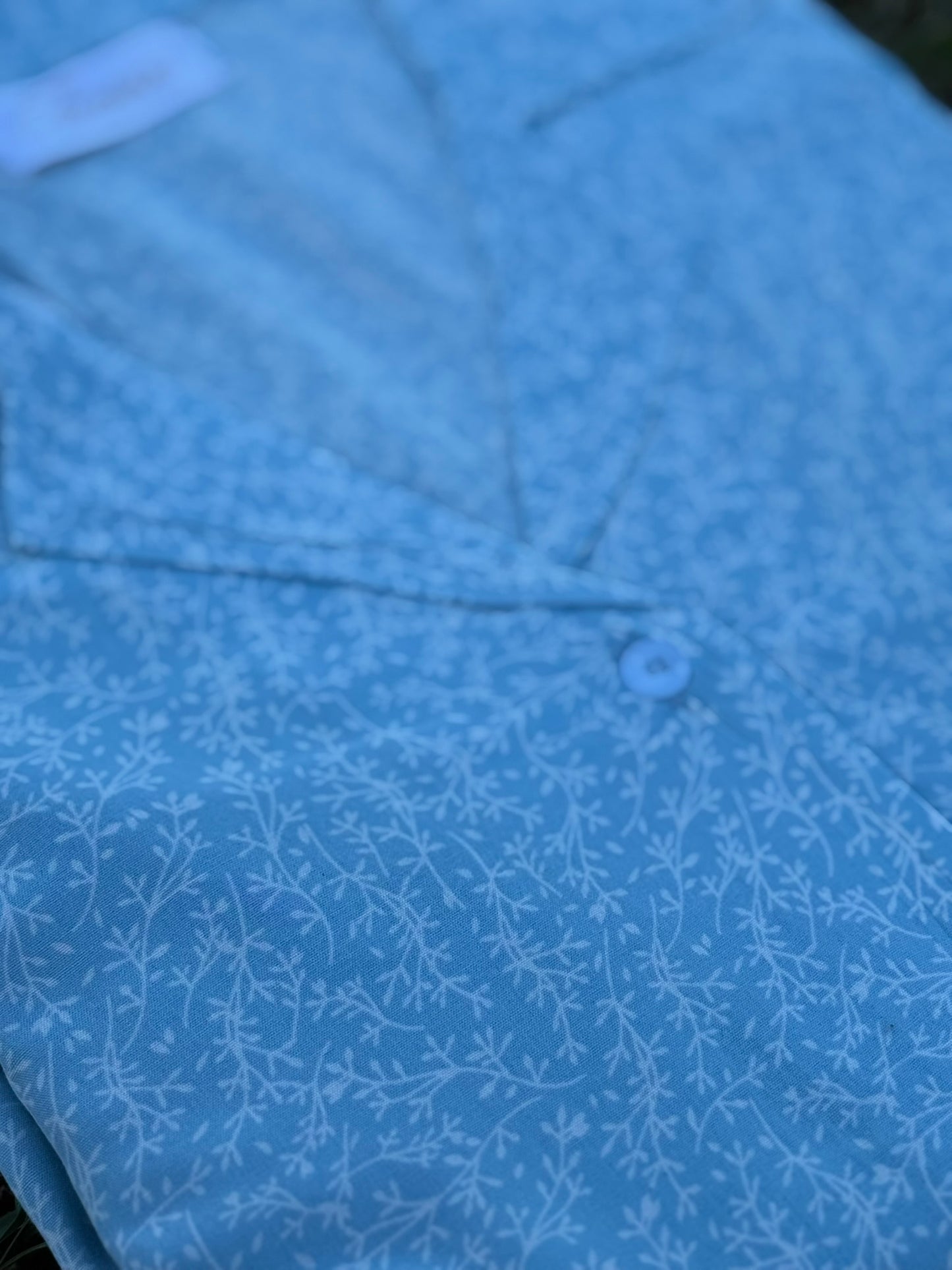 Serene Thread’s Iconico Whisper button-up in sky blue linen featuring white branches print