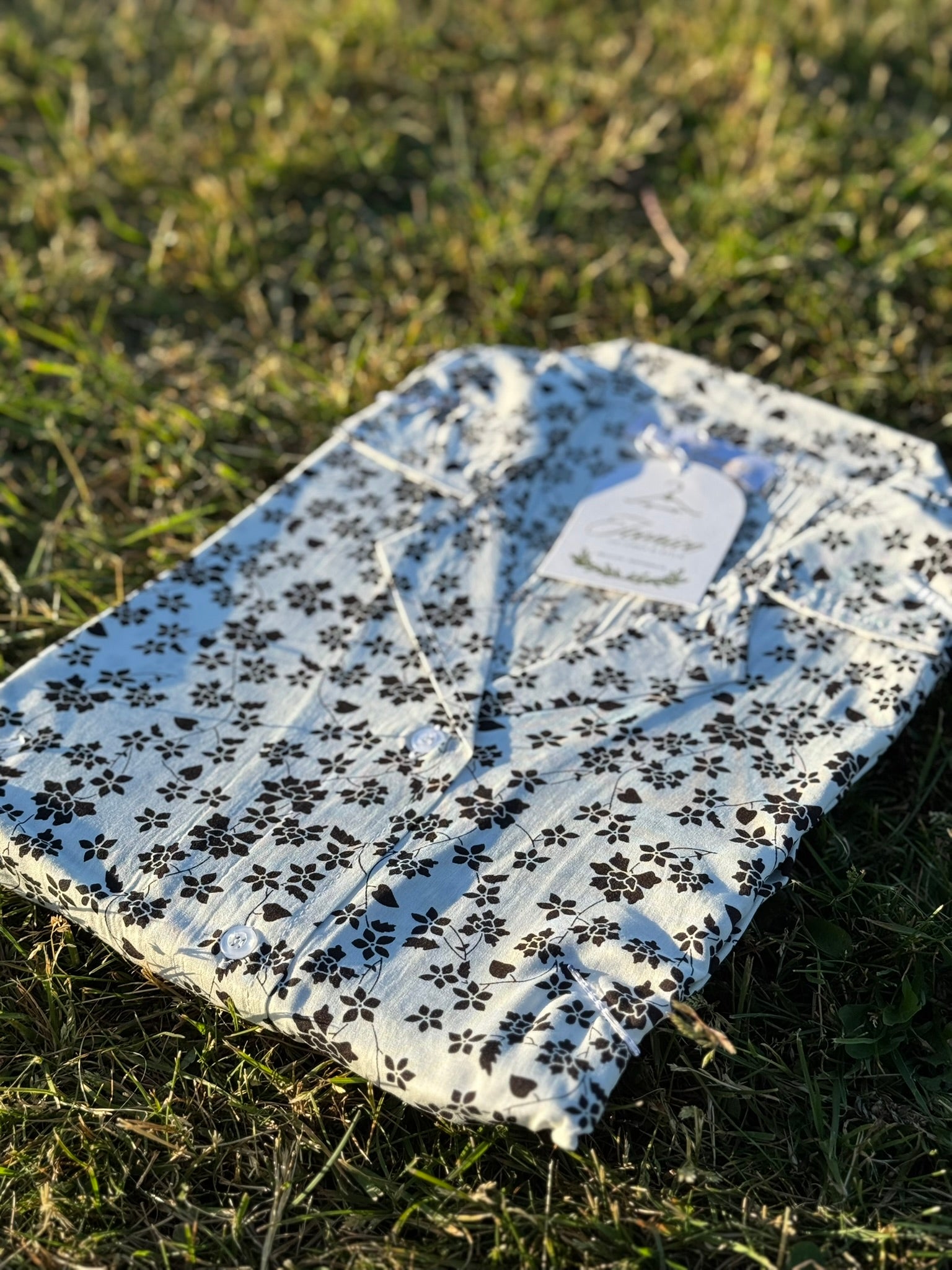 Elegant white linen dress with bold black floral design – Iconico Blossom by Serene Thread